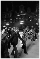 Girls skating by night, Hotel de Ville. Paris, France (black and white)