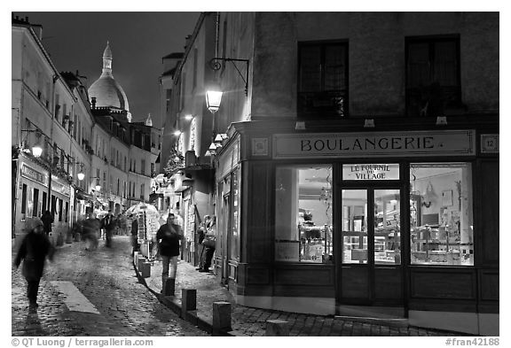 Bakery, street and dome of Sacre-Coeur at twilight, Montmartre. Paris, France