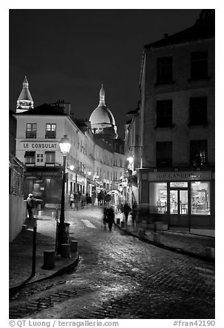 Street and Sacre-Coeur dome at night, Montmartre. Paris, France