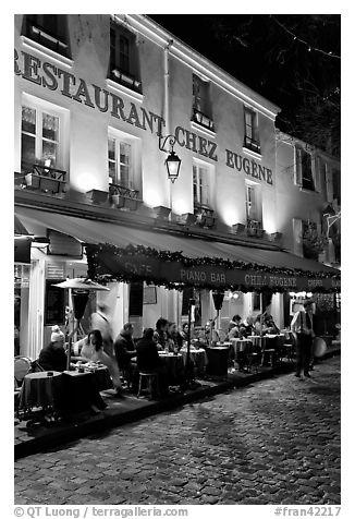 Restaurant with outdoor sitting by night, Montmartre. Paris, France (black and white)