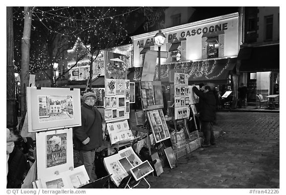 Art for sale on Place du Tertre at night, Montmartre. Paris, France (black and white)