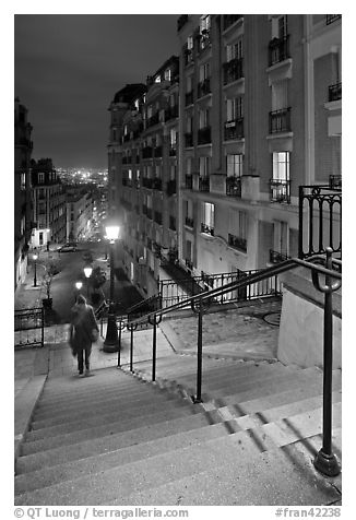 Woman on stairs by night, Montmartre. Paris, France