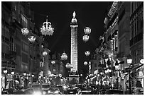 Street with lights and Place Vendome column. Paris, France (black and white)