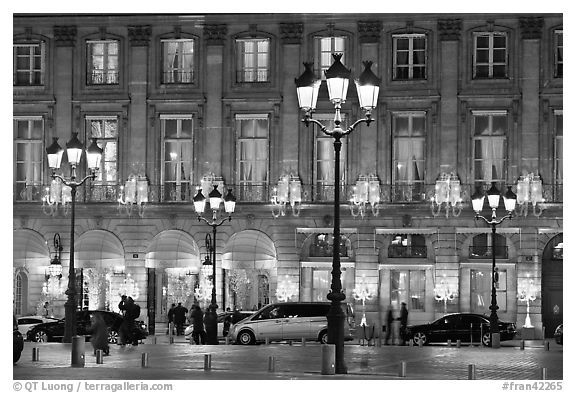 Lights and palace-like classical fronts of Hotel Ritz by Jules Hardouin-Mansart. Paris, France (black and white)