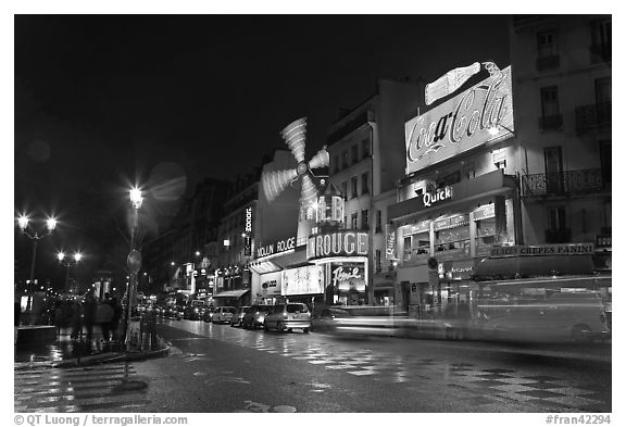 Boulevard by night with Moulin Rouge. Paris, France