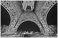 Eiffel Tower pilars from below and Ecole Militaire at night. Paris, France ( black and white)