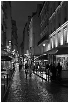 Pedestrian street with restaurants at night. Quartier Latin, Paris, France (black and white)