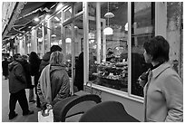 Customers wait in line in front of a popular bakery. Paris, France (black and white)