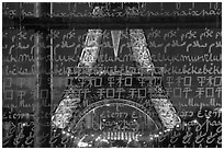 Lit Eiffel Tower seen through the words Peace written in many languages. Paris, France ( black and white)