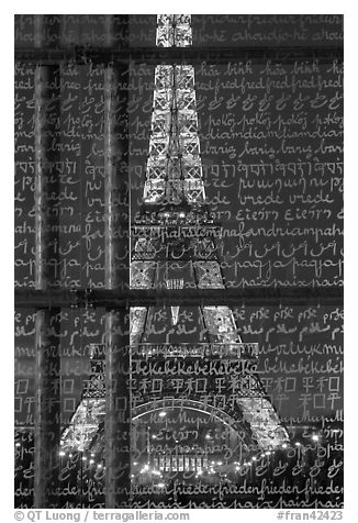 Illuminated Eiffel Tower seen through peace memorial. Paris, France