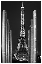 Columns of memorial to peace end Eiffel Tower by night. Paris, France (black and white)