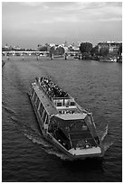 Bateau-mouche (tour boat) on Seine River. Paris, France (black and white)