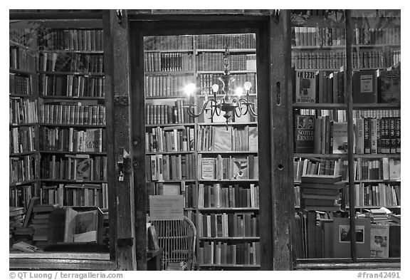 Books on shelves seen through storefront. Quartier Latin, Paris, France (black and white)