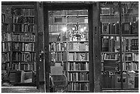 Books on shelves seen through storefront. Quartier Latin, Paris, France (black and white)