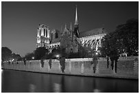 Side view of Notre Dame across Seine River at dusk. Paris, France (black and white)