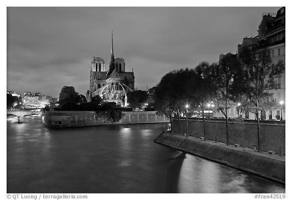 Banks of the Seine River, Ile de la Cite, Ile Saint Louis, and Notre Dame at twilight. Paris, France (black and white)
