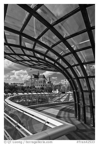 Curvy glass and metal structure framing historic Saint-Eustache church. Paris, France (black and white)