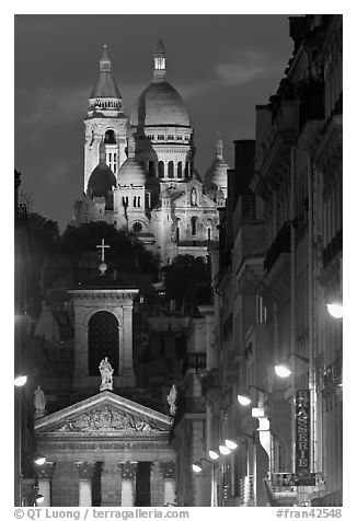 Church of Notre-Dame-de-Lorette with the Basilica of the Sacre Coeur behind at night. Paris, France (black and white)