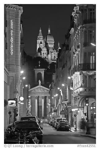 Street, Notre-Dame-de-Lorette, and Sacre Coeur at night. Paris, France (black and white)