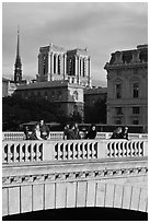 Watching the sunset from a bridge, with Notre Dame towers behind. Paris, France (black and white)