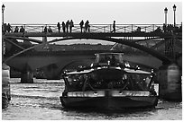 Tour boat below Pont des Arts at sunset. Paris, France (black and white)