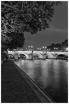 Ile de la Cite quay and illuminated Pont-Neuf. Paris, France (black and white)