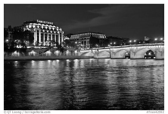 Pont Neuf and Samaritaine reflected in Seine River at night. Paris, France (black and white)