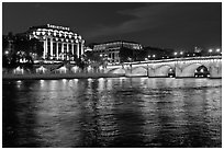 Pont Neuf and Samaritaine reflected in Seine River at night. Paris, France (black and white)