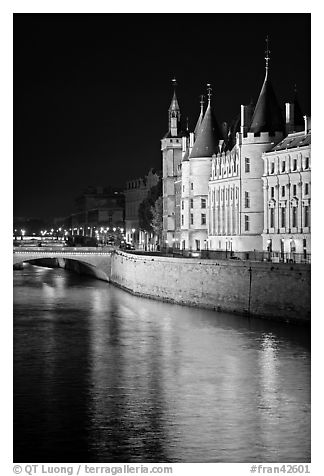 Conciergerie reflected in Seine river at night. Paris, France