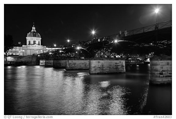 Institut de France, Pont des Arts and Seine reflections at night. Paris, France