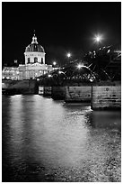 Institut de France and Pont des Arts reflected in Seine river at night. Paris, France (black and white)