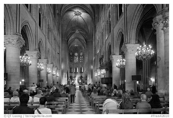 Interior of Notre-Dame de Paris during mass. Paris, France (black and white)