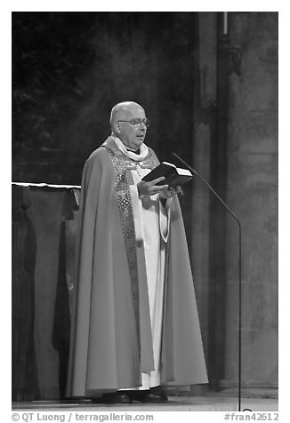 Cardinal of catholic church reading in Notre-Dame. Paris, France