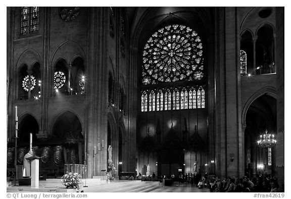 Bishop celebrating mass, South transept, and stained glass rose. Paris, France (black and white)