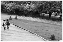 Couple walking down steps in park, Montmartre. Paris, France ( black and white)