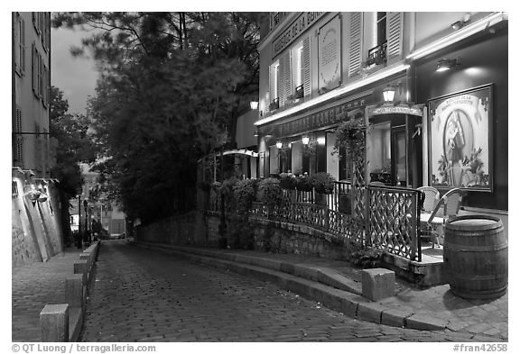 Cobblestone street and restaurant at dusk, Montmartre. Paris, France