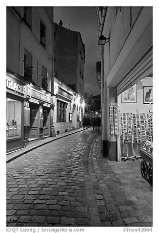 Pedestrian cobblestone street and tourist business, Montmartre. Paris, France (black and white)