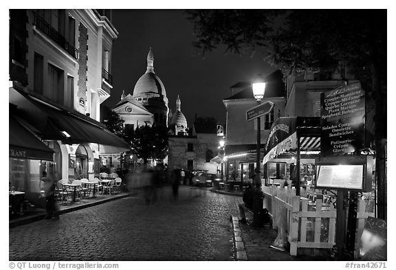 Place du Tertre at night with restaurants and Basilique du Sacre-Coeur, Montmartre. Paris, France