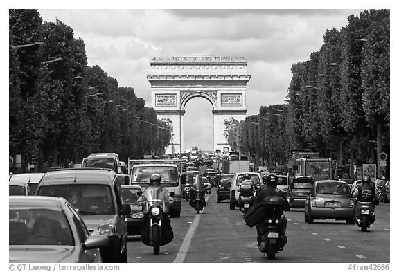 Car and motorcycle traffic and Arc de Triomphe, Champs-Elysees. Paris, France (black and white)