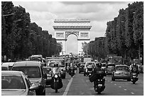 Car and motorcycle traffic and Arc de Triomphe, Champs-Elysees. Paris, France (black and white)