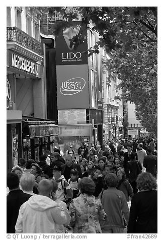 Pedestrians on a Champs-Elysees sidewalk. Paris, France