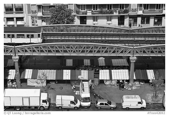 Aerial portion of metro from above, with public market stalls below. Paris, France (black and white)