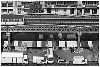 Aerial portion of metro from above, with public market stalls below. Paris, France (black and white)