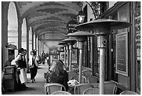 Outdoor cafe tables and heating lamps, place des Vosges. Paris, France ( black and white)