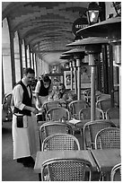 Waiters and customer, place des Vosges arcades. Paris, France (black and white)