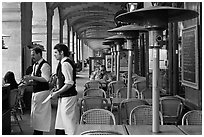 Waiters and cafe in place Victor Hugo arcades. Paris, France (black and white)