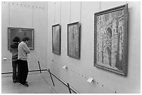 Tourists looking at Monet's Rouen Cathedral, Orsay Museum. Paris, France ( black and white)