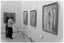 Tourists looking at Monet's Rouen Cathedral, Orsay Museum. Paris, France (black and white)