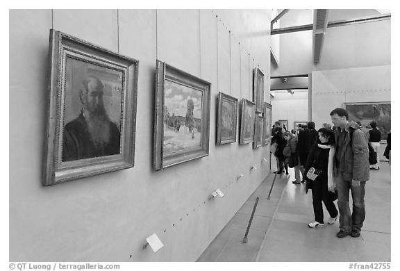 Couple looking at impressionists paintings, Orsay Museum. Paris, France (black and white)