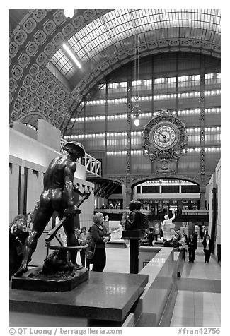 Sculpture and historic clock inside Orsay Museum. Paris, France (black and white)